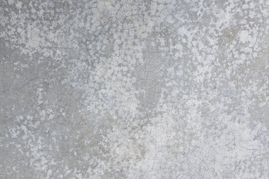 Cracked and Weathered Grey Concrete Wall Texture,Macro,A detailed full-frame texture photograph capturing an aged grey concrete wall with a complex network of deep, extensive cracks and weathering.