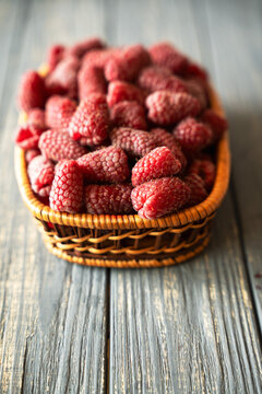 Fresh organic raspberries on wooden table background, food blogging, healthy eating concepts, and seasonal summer harvest themes. Small Farm food 