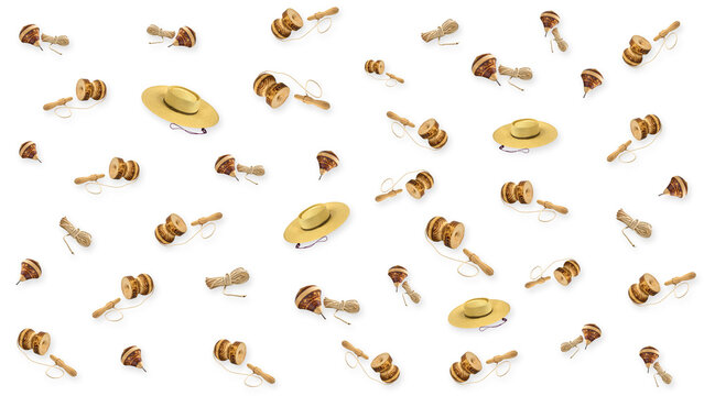 Wooden chilen cup and ball, spinning tops, and straw hats forming a playful pattern on white background