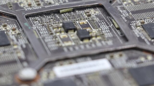 Dusty microchip or PC board, rotating close-up view revealing its intricate design and components.