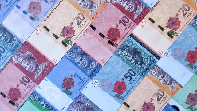 Malaysian ringgit banknotes as a tool for trade and financial transactions. The Malaysian ringgit as a background for your design