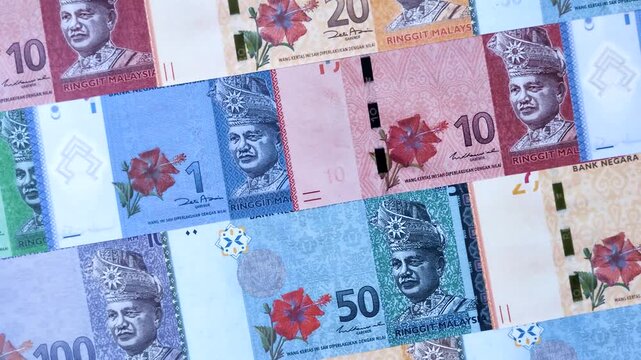 Malaysian ringgit banknotes as a tool for trade and financial transactions. The Malaysian ringgit as a background for your design