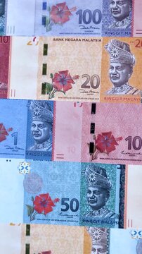 Malaysian ringgit banknotes as a tool for trade and financial transactions. The Malaysian ringgit as a background for your design
