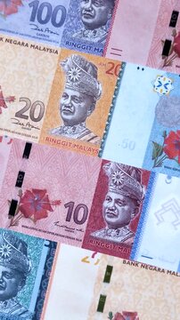 Malaysian ringgit banknotes as a tool for trade and financial transactions. The Malaysian ringgit as a background for your design
