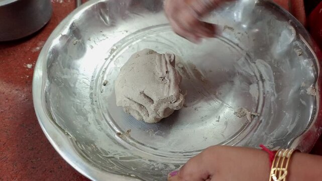 Indian Woman Kneading Bajra Dough and Hand Flattening Pearl Millet Bhakri Roti