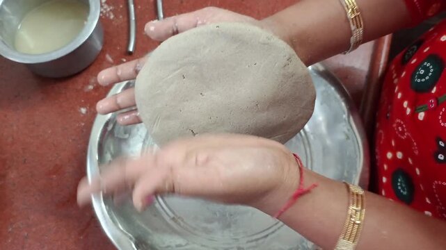 Indian Woman Kneading Bajra Dough and Hand Flattening Pearl Millet Bhakri Roti