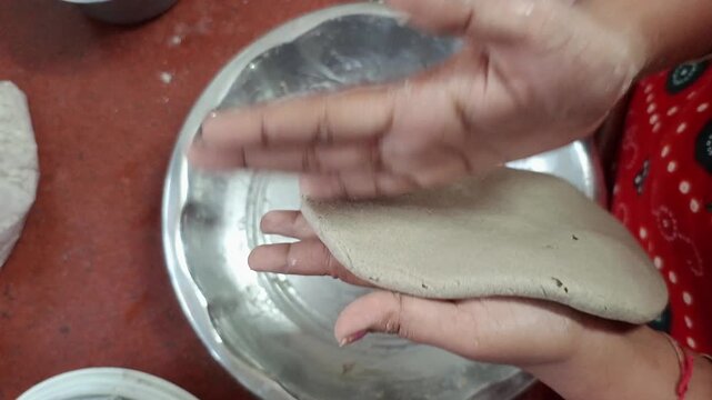 Indian Woman Kneading Bajra Dough and Hand Flattening Pearl Millet Bhakri Roti