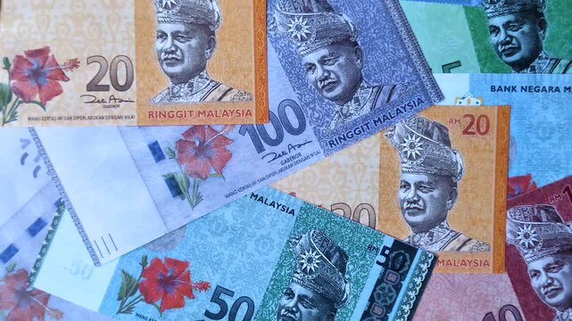 Malaysian ringgit banknotes as a tool for trade and financial transactions. The Malaysian ringgit as a background for your design