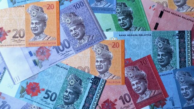 Malaysian ringgit banknotes as a tool for trade and financial transactions. The Malaysian ringgit as a background for your design