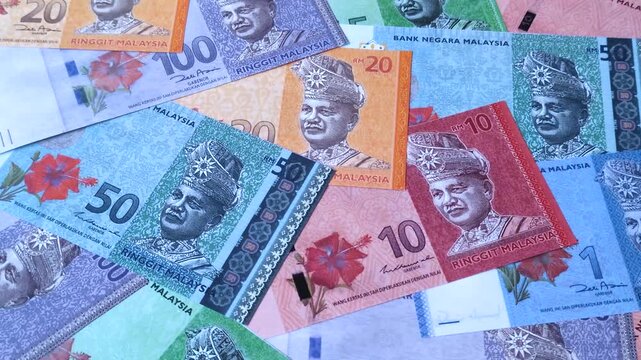 Malaysian ringgit banknotes as a tool for trade and financial transactions. The Malaysian ringgit as a background for your design