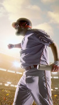 Baseball batter follow-through after swinging bat under golden daytime sky