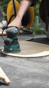 DIY Furniture Makeover: Woman Using Power Tools to Renovate an Old Wooden Chair at Home