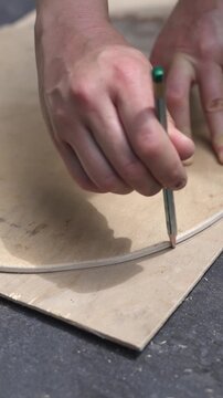 Woman hand sanding and restoring an old wooden chair, removing old finish and preparing furniture for DIY renovation, repair and sustainable upcycling
