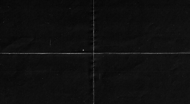 Dark black folded paper texture background with crease lines