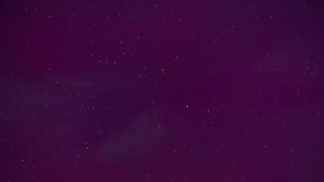 View of vibrant aurora borealis illuminating the night sky with purple and green light patterns above Boise, Idaho, United States.