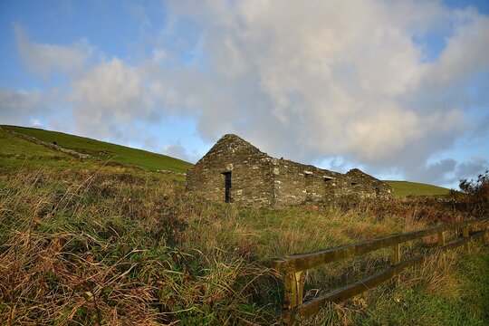 Irish rural landscape with scenic view of an abandoned stone built Cloch&aacute;n in the countryside of Doolin in County Clare, Ireland.