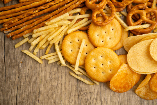 Mix of variety snack chips pretzel and cracker, junk crunchy food.