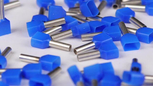Metal tips with a plastic base for mounting on stranded copper wires. Close-up. Soft focus. Macro.