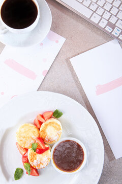 Cheesecakes with strawberry jam. Strawberry slices with cheesecakes. Healthy breakfast. Menu page in cafe and rose on table. Top view