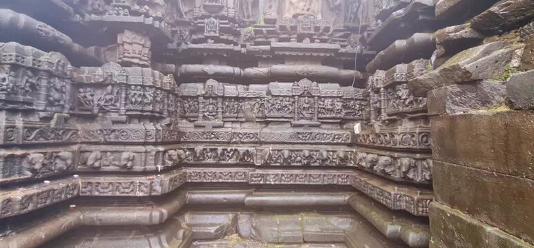 Intricate Deep Stone Carvings and Weathered Bas Relief Sculptures on Ancient Wall of Shri Ambareshwar Shiva Temple in Maharashtra 