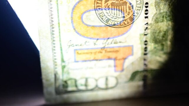 illuminated 100 dollar's textured bill moving illuminated abstract financial background B roll video