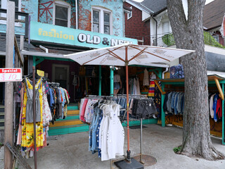 Obraz premium Vintage clothing store with outdoor display on sidewalk, Kensington Market bazaar, Toronto