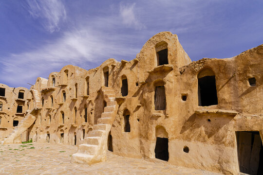 View of the historic Ksar Ouled Soltane with traditional multi-level vaulted granary chambers, stone staircases, and weathered clay walls in Tataouine, Tataouine Governorate, Tunisia.