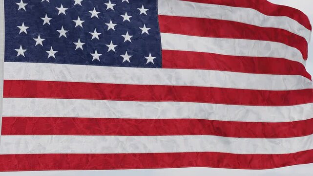 Close up of the American flag waving in the wind with visible texture