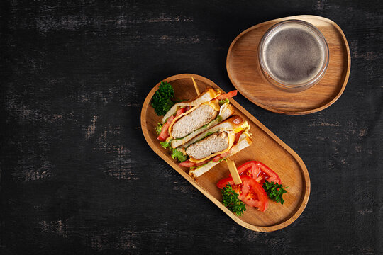 Chicken Sandwich with Cheese and Tomato Served with Coffee on Wooden Tray. Top view