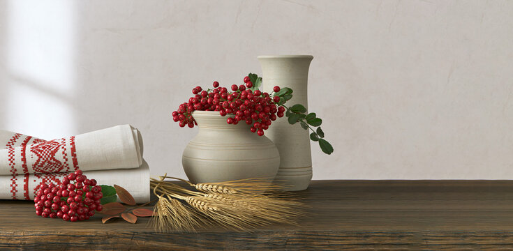 Traditional autumn still life with red rowan berries, wheat, ceramic pottery and embroidered cloth on rustic wooden table, copy space