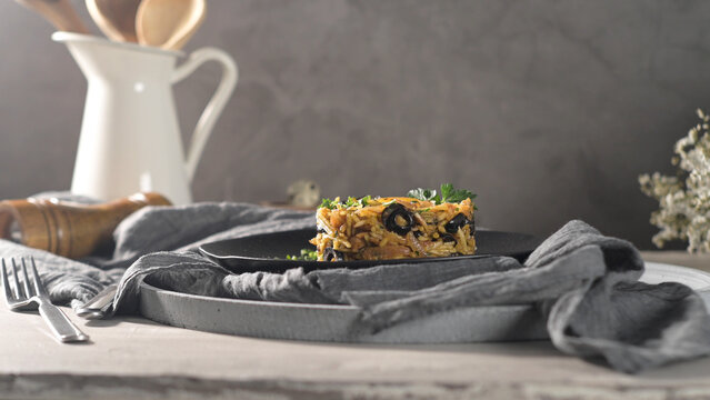 Bacalhau a Bras Portuguese Codfish with Olives on Dark Plate