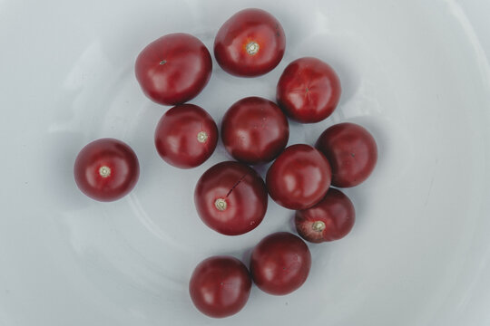 View of fresh red cherry tomatoes on a white plate Laane County, Estonia.