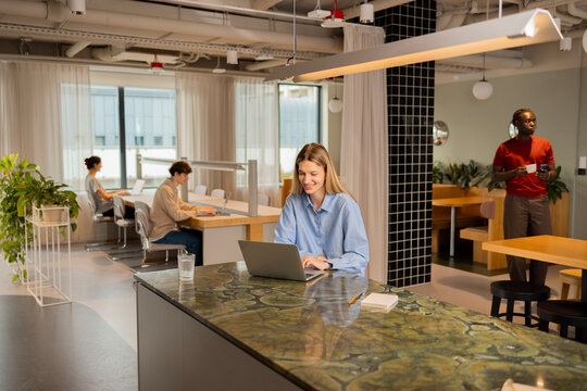 woman  using laptops in a modern coworking office workplace