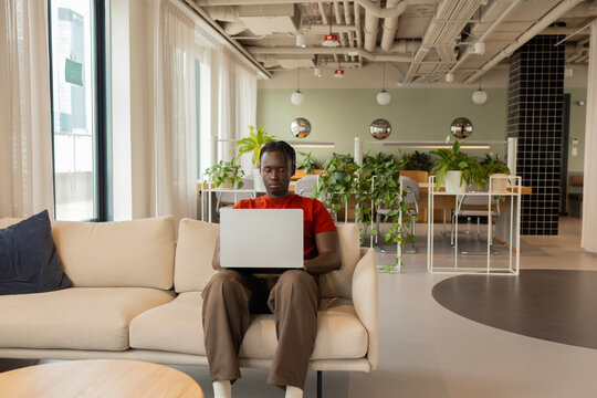 man working on laptop in modern business workplace