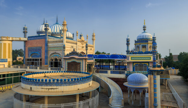 View of the ornate Jamia Masjid Bhong Sharif with its intricate blue and white tile work, domes, and decorative architectural features in Bhong, Punjab, Pakistan.