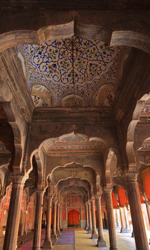View of the intricate arches and detailed floral ceiling paintings inside the historic Shahi Mosque in Chiniot, Punjab, Pakistan.