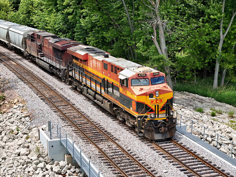 Savanna, Illinois June 23, 2026 Kansas City Southern locomotive 4794, leads a freight train through a lush, tree‑lined corridor on a double‑track mainline.