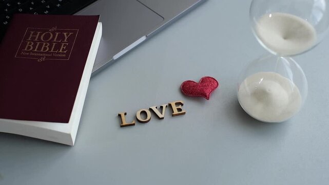 Ideas for love and faith with a Bible and heart symbol on a gray desk