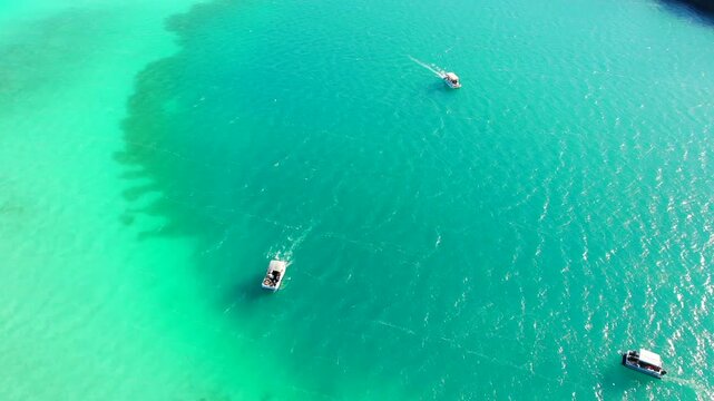 Cenote Cocalitos. Boats in turquoise water of seven colores lagoon near Bacalar, Quintana Roo, Mexico
