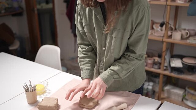 Artisan Kneading Raw Clay by Hand 4K Video Slow Motion. Close-up manual action of clay wedging
