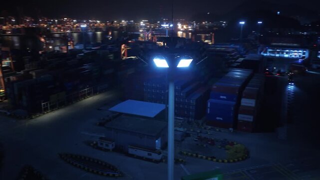 Unloading large cargo containers seaport. Loading freight sea port. Top aerial drone view. Lot big boxes rows, ship delivery ocean harbor. Shipping night. Goods export import. Industrial Marine dock.