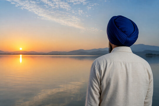 Back view of person wearing Sikh turban by tranquil lake, spirituality and tradition concept