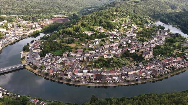 Montherme town nestled in a river meander of the Meuse river during daylight hours