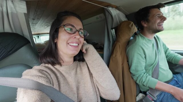 Couple vlogging van life while driving on road trip