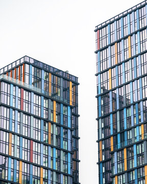 View of modern skyscrapers with colorful glass facades and geometric patterns in London, England, United Kingdom.