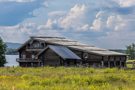 View of the traditional wooden architecture at Kizhi Pogost surrounded by wildflowers and lush greenery near Lake Onega in Petrozavodsk, Republic of Karelia, Russia.