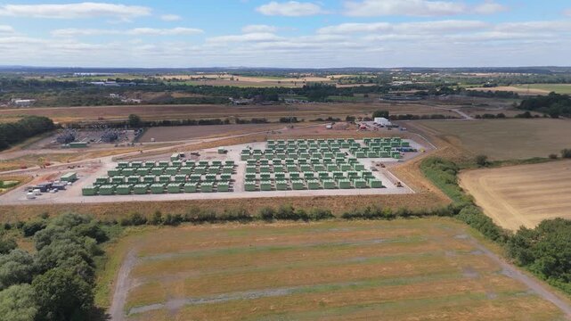 Drone orbit of a large scale Battery Energy Storage Site with lithium iron phosphate batteries stored in cabinets on a large utility scale development in Coleshill, Birmingham