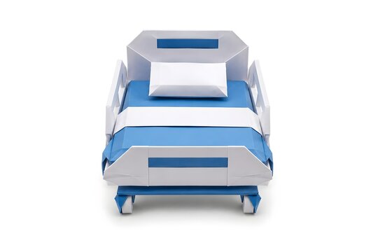 Origami Hospital Bed with Folded Pillow and Blanket in Blue and White Paper Isolated on White Background