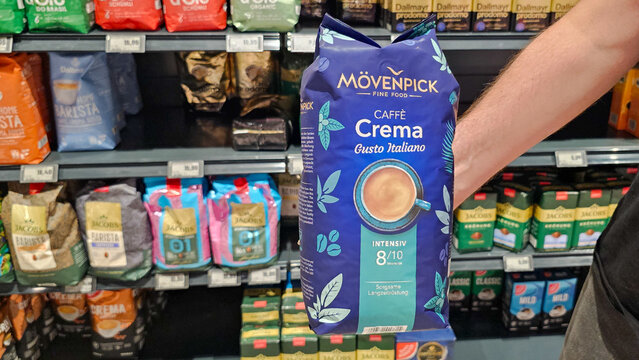 Hand picking movenpick caffe crema coffee in supermarket