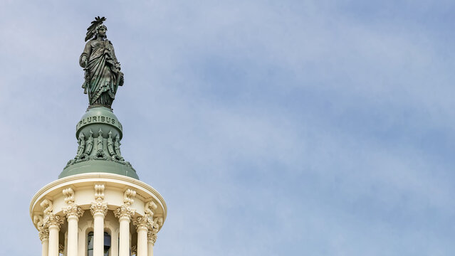Statue of Freedom Above United States Capitol Dome With Blue Sky Copy Space Washington DC